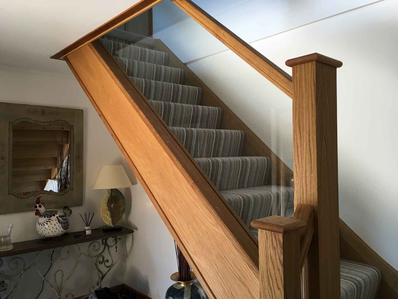 Staircase with waterfall stripe carpet completed in Oak by One Stop Joinery with Oak wood and toughened safety glass.