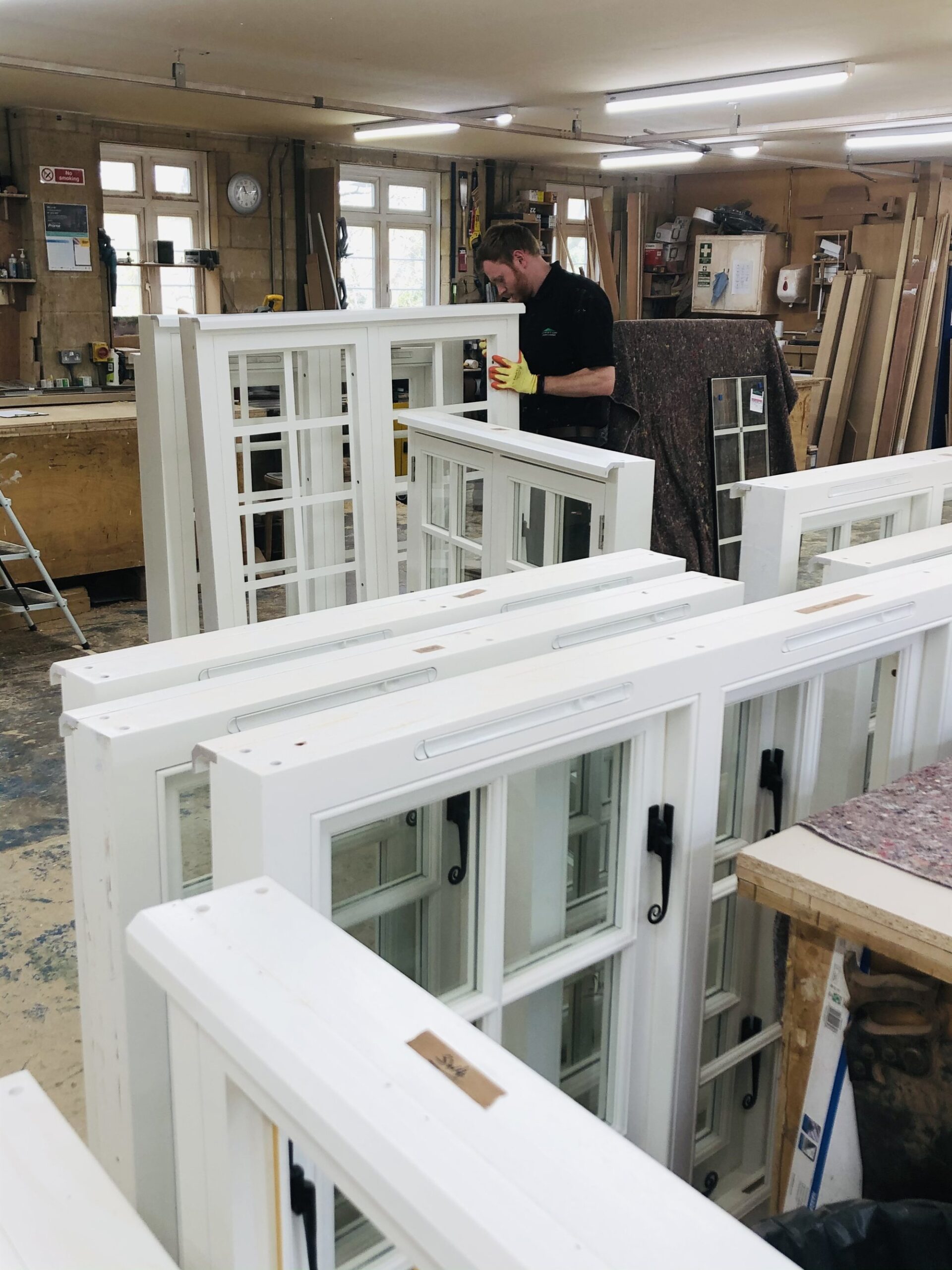 joiner in west sussex one stop joinery workshop after spraying white casement windows with farrow and ball paint